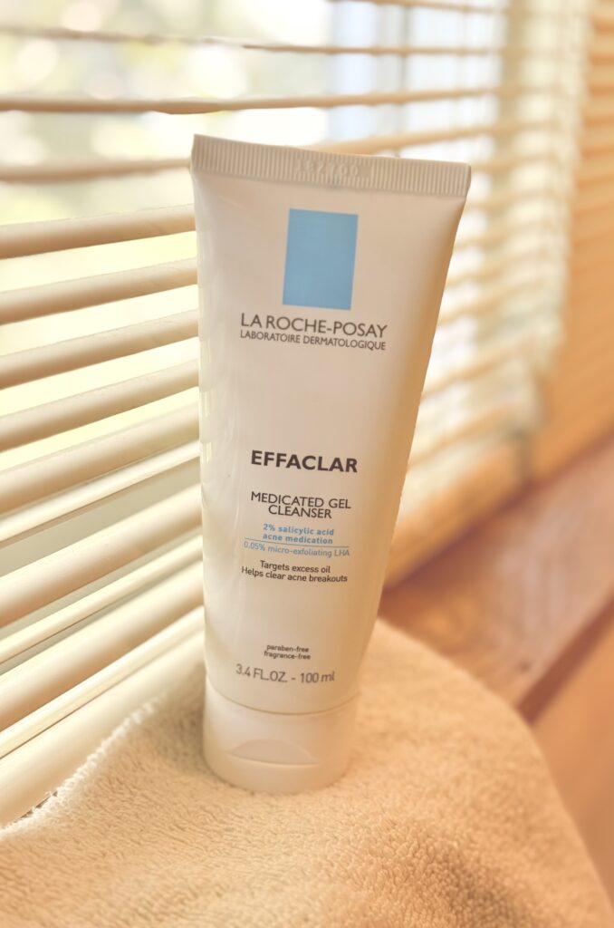 A bottle of la roche-posay salicylic acid wash sitting on a window sill. 