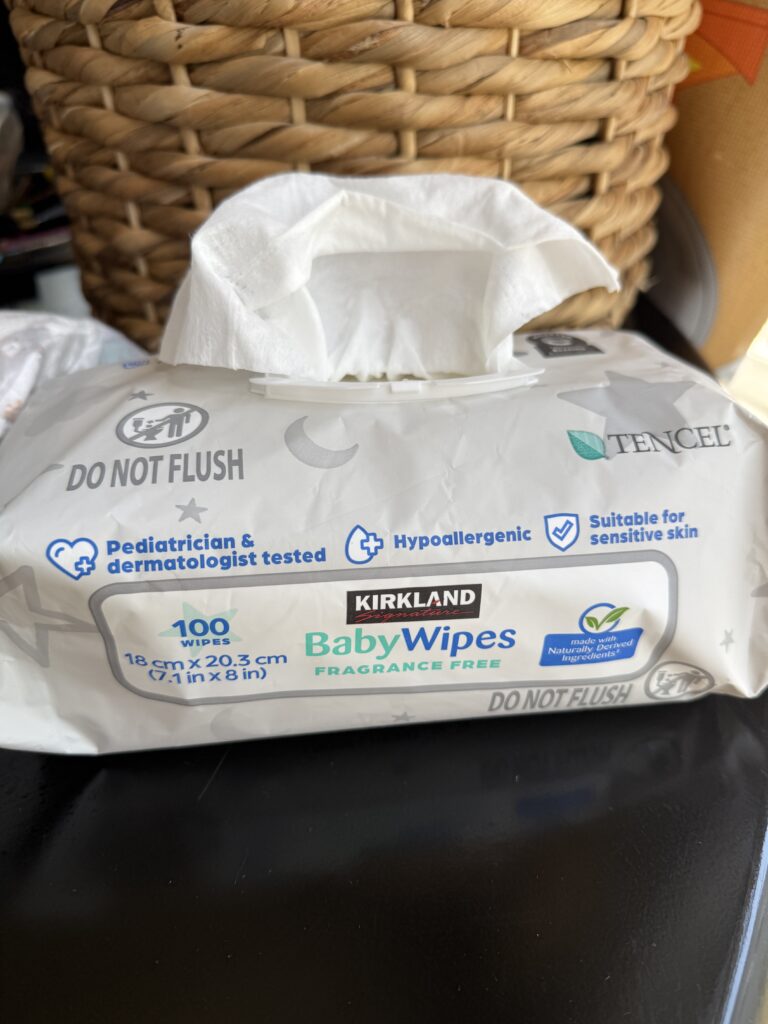 Kirkland Signature Baby Wipes on table with basket in the background